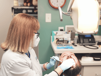 Dentist treating a family friend who has paid for their treatment.
