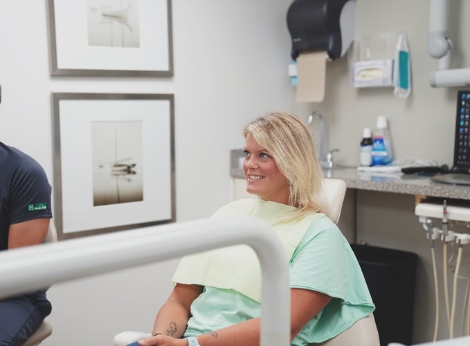 Dental patient in chair benefitting from dental practice efficiency