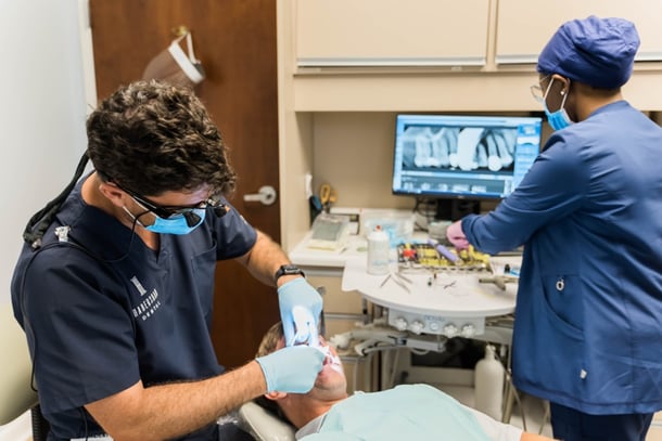 Dentist treating patient after insurance verification