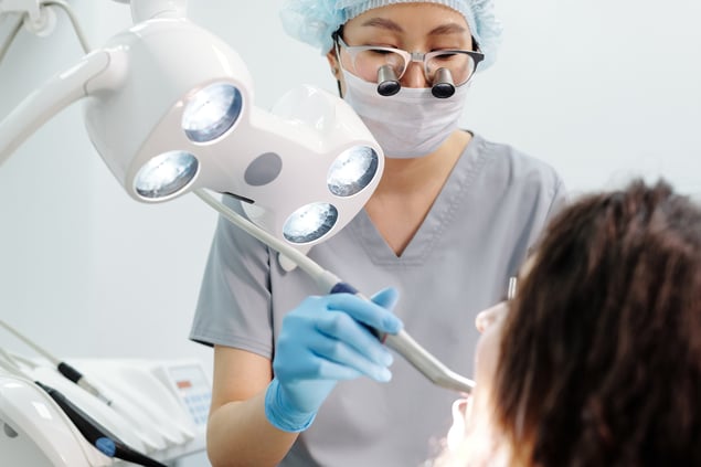 Dentist examining patient for abutment or implant supported crowns